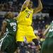 Michigan freshman Trey Burke looks to pass the ball around Ohio University junior D.J. Cooper in the first half of the second round of the NCAA tournament at Bridgestone Arena in Nashville, Tenn.  Melanie Maxwell I AnnArbor.com